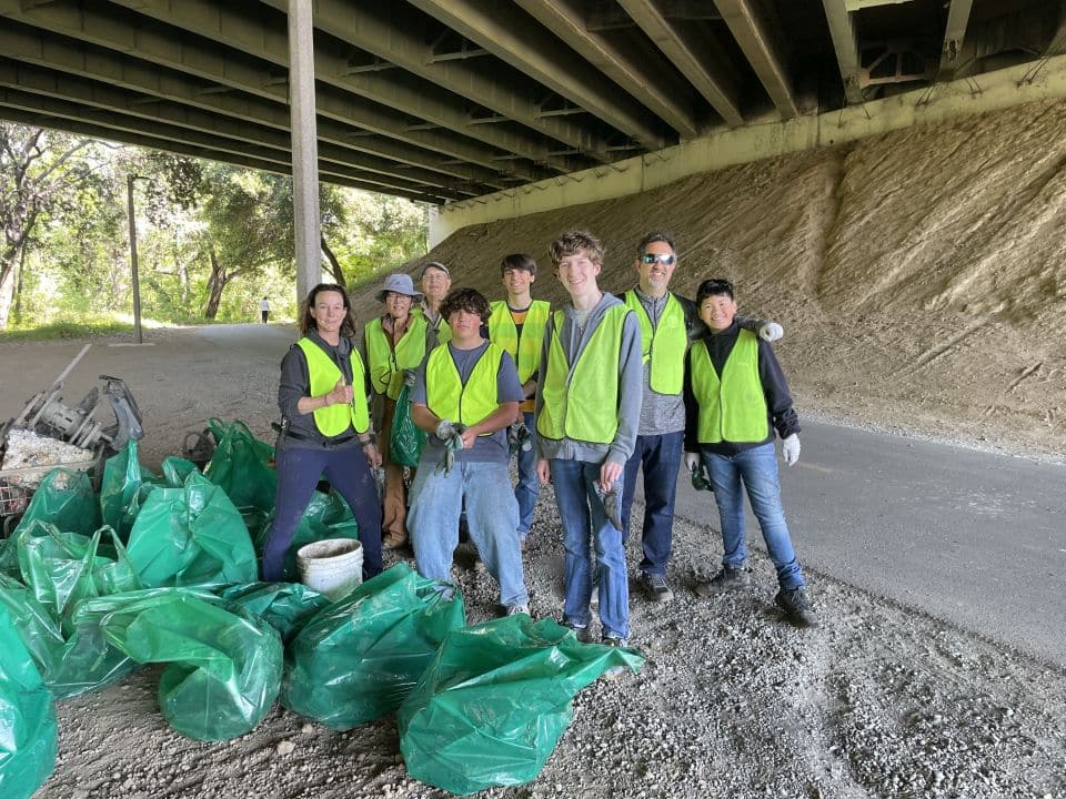 group posing with garbage bags